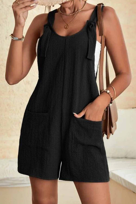 Romper, Black, textured with pockets and adjustable straps.